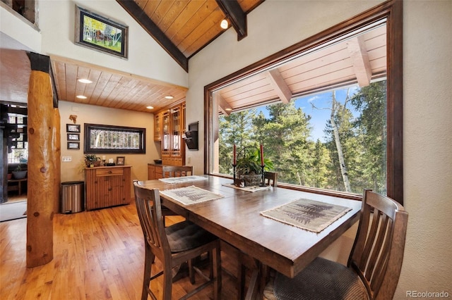 266 Lodgepole Dr, Evergreen, CO 80439 - dining space with light wood-type flooring, wooden ceiling, a wealth of natural light, and beam ceiling