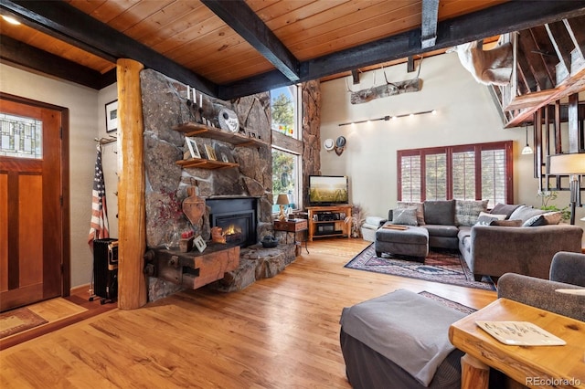 266 Lodgepole Dr, Evergreen, CO 80439 - living room featuring light wood finished floors, a fireplace, wood ceiling, and a healthy amount of sunlight
