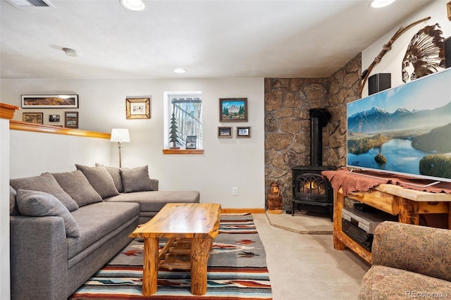 266 Lodgepole Dr, Evergreen, CO 80439 - carpeted living room with visible vents, baseboards, a wood stove, and recessed lighting