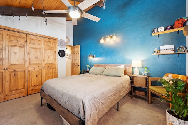 266 Lodgepole Dr, Evergreen, CO 80439 - bedroom with light carpet, beamed ceiling, and wooden ceiling