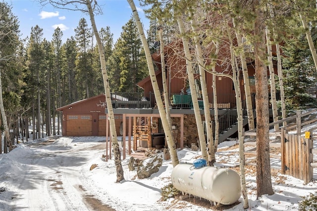 266 Lodgepole Dr, Evergreen, CO 80439 - rustic home with a garage and a wooden deck