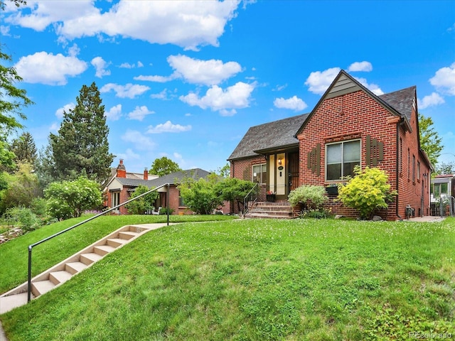 1247 Dexter St, Denver, CO 80220 - english style home with brick siding, a front lawn, and a shingled roof