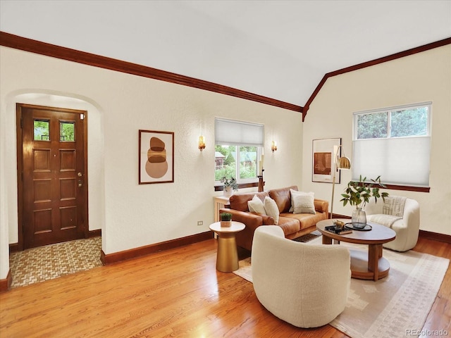 1247 Dexter St, Denver, CO 80220 - living area featuring ornamental molding, light wood-type flooring, vaulted ceiling, baseboards, and arched walkways
