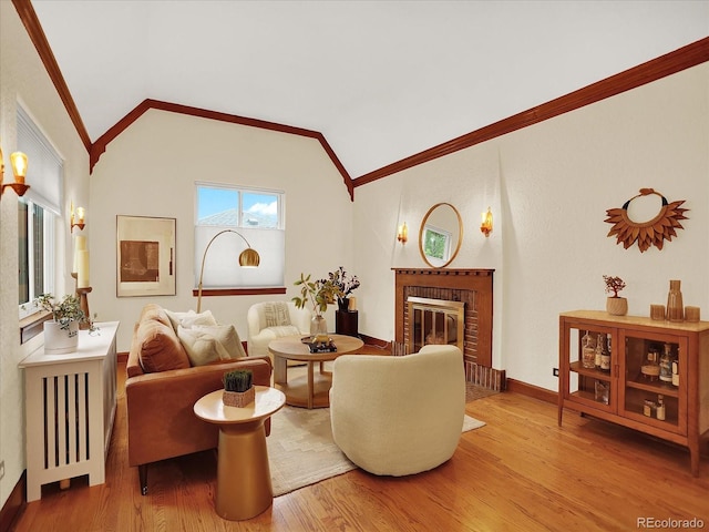 1247 Dexter St, Denver, CO 80220 - living room with lofted ceiling, crown molding, wood finished floors, a brick fireplace, and baseboards