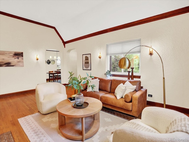 1247 Dexter St, Denver, CO 80220 - living area featuring ornamental molding, vaulted ceiling, arched walkways, wood finished floors, and baseboards