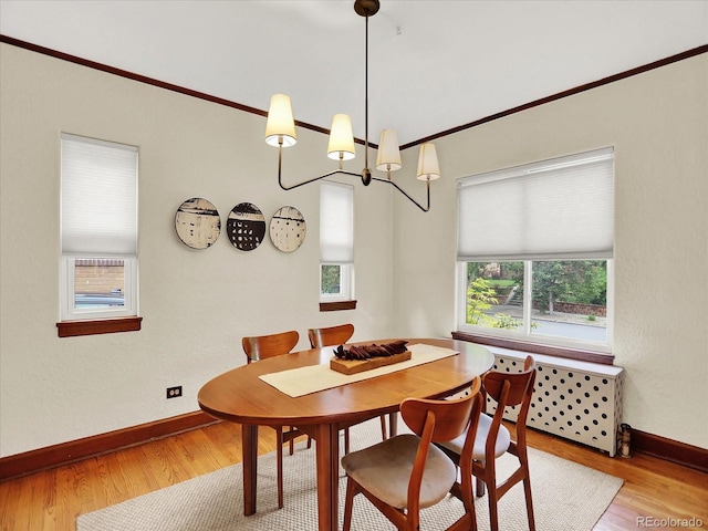 1247 Dexter St, Denver, CO 80220 - dining space with wood finished floors, baseboards, a chandelier, and ornamental molding