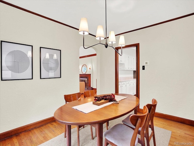 1247 Dexter St, Denver, CO 80220 - dining room with baseboards, light wood-style flooring, crown molding, and a chandelier