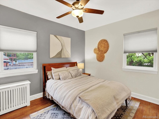 1247 Dexter St, Denver, CO 80220 - bedroom featuring radiator, baseboards, wood finished floors, and ceiling fan
