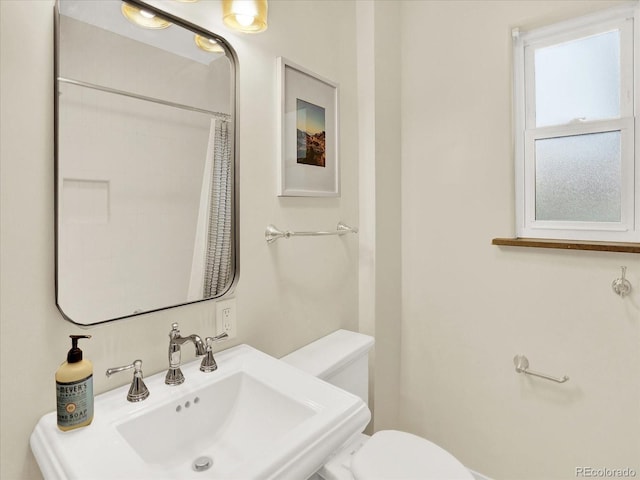 1247 Dexter St, Denver, CO 80220 - bathroom featuring toilet, a sink, and curtained shower