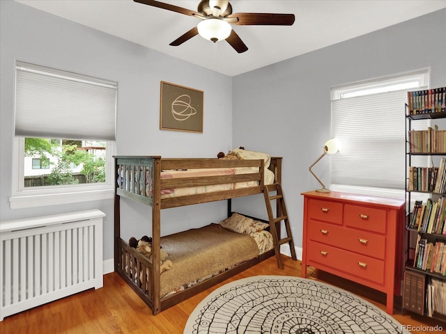 1247 Dexter St, Denver, CO 80220 - bedroom featuring radiator, wood finished floors, baseboards, and a ceiling fan