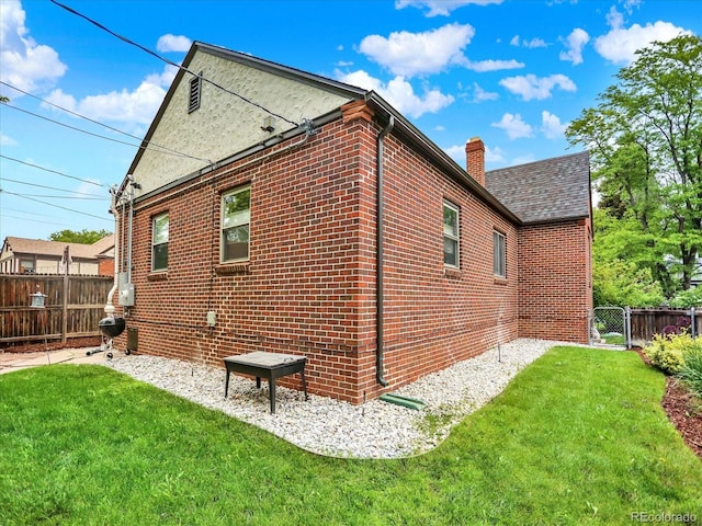 1247 Dexter St, Denver, CO 80220 - view of property exterior featuring brick siding and a chimney