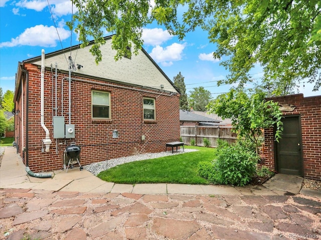 1247 Dexter St, Denver, CO 80220 - rear view of property featuring brick siding and a patio