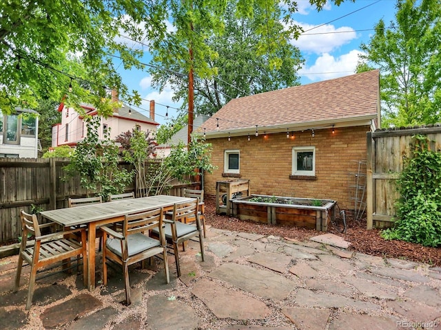 1247 Dexter St, Denver, CO 80220 - fenced backyard featuring outdoor dining space, a patio area, and a vegetable garden