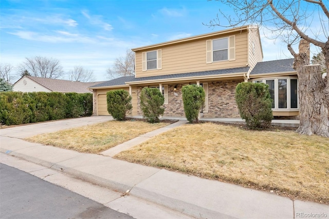 traditional-style house featuring an attached garage, brick siding, concrete driveway, roof with shingles, and a front lawn