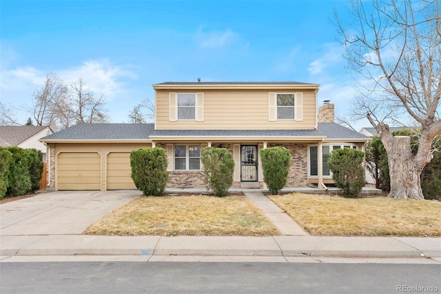 traditional-style home featuring an attached garage, concrete driveway, brick siding, and a front yard