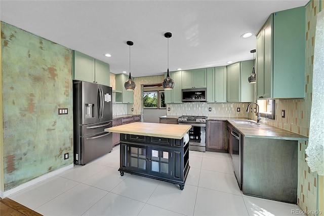 3145 S Bryant St, Sheridan, CO 80110 - kitchen featuring stainless steel appliances, green cabinetry, decorative backsplash, wooden counters, and recessed lighting