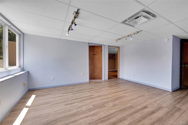 3145 S Bryant St, Sheridan, CO 80110 - unfurnished room with track lighting, light wood-style floors, and a drop ceiling