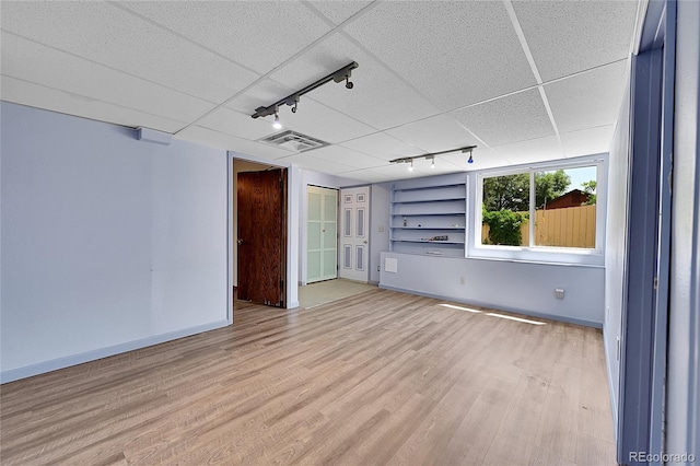 3145 S Bryant St, Sheridan, CO 80110 - unfurnished room featuring track lighting, light wood-style flooring, and built in features