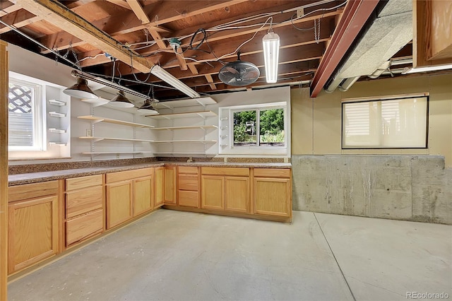 3145 S Bryant St, Sheridan, CO 80110 - kitchen with open shelves, finished concrete floors, and light brown cabinets