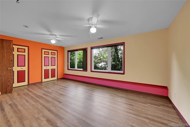 3145 S Bryant St, Sheridan, CO 80110 - spare room with wood finished floors, ceiling fan, and a baseboard radiator