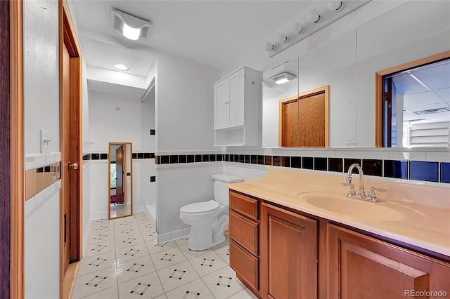3145 S Bryant St, Sheridan, CO 80110 - full bath with tile patterned floors, vanity, and a wainscoted wall