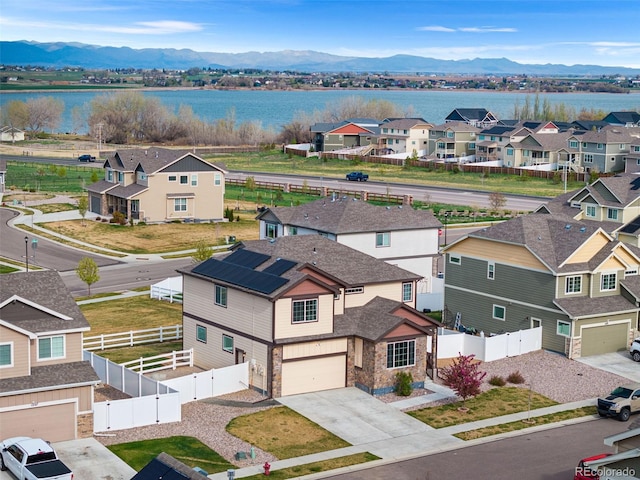 aerial view with a water and mountain view and a residential view