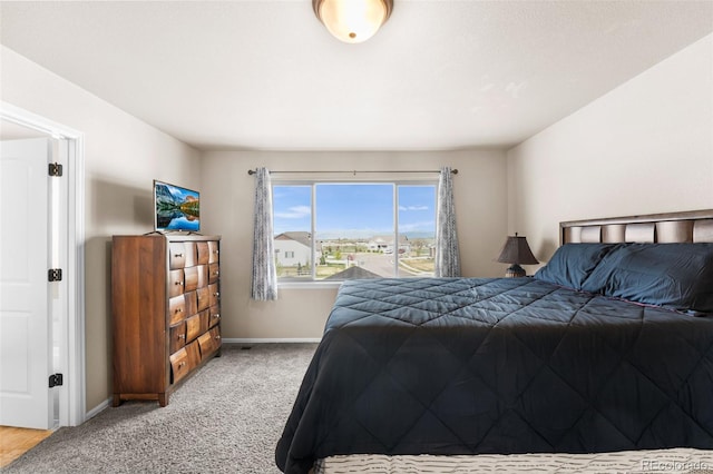 bedroom featuring baseboards and light carpet