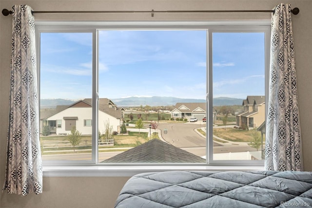 doorway to outside featuring a residential view, a mountain view, and a healthy amount of sunlight