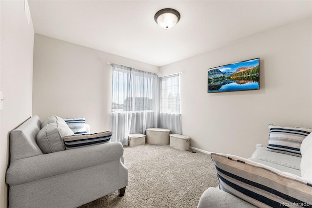living area featuring carpet flooring and baseboards