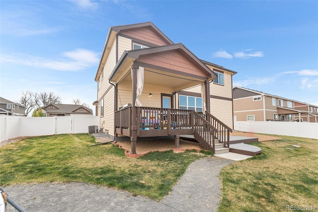 view of front of property with a fenced backyard, central air condition unit, a front lawn, and a deck