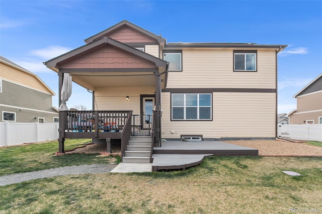 back of property featuring a fenced backyard, a yard, and a deck