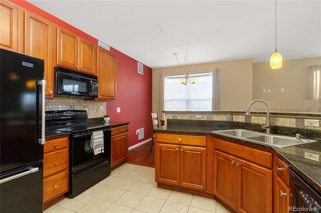 kitchen featuring decorative light fixtures, sink, backsplash, light tile patterned floors, and black appliances