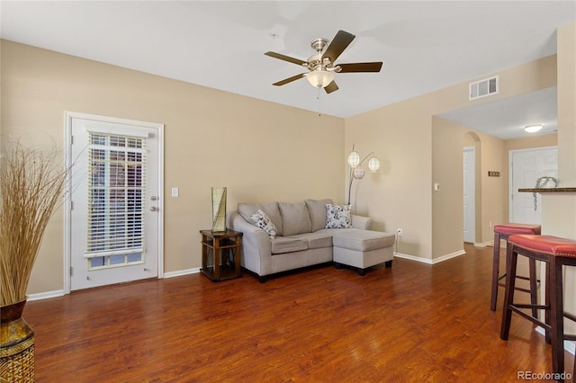 living room with dark hardwood / wood-style floors and ceiling fan