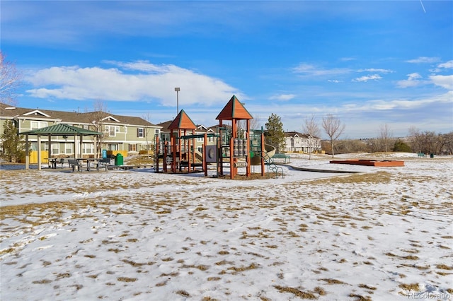 snow covered playground with a gazebo