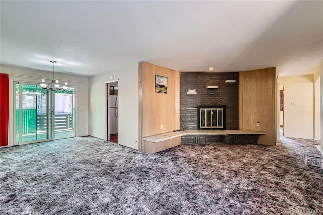 unfurnished living room with a fireplace and carpet