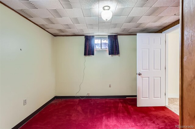 below grade area featuring carpet flooring and baseboards