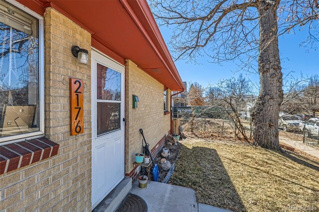 exterior space with brick siding and fence