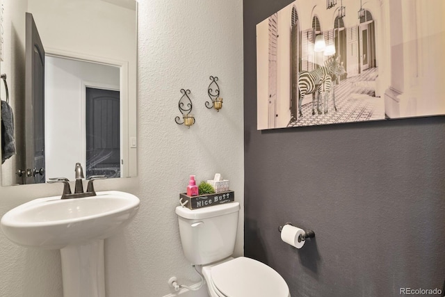 16002 E 111th Cir, Commerce City, CO 80022 - bathroom with a textured wall, toilet, and a sink