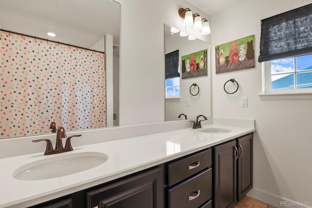 16002 E 111th Cir, Commerce City, CO 80022 - full bathroom with double vanity, tile patterned flooring, baseboards, and a shower with curtain