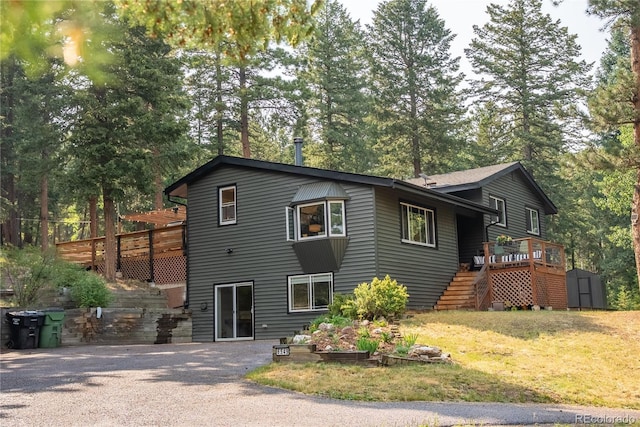 6549 Modoc Ln, Evergreen, CO 80439 - view of front of home featuring a shed, stairway, a wooden deck, a front yard, and view of scattered trees