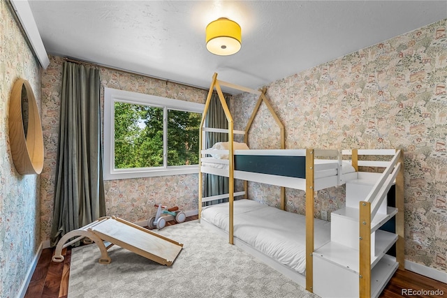 6549 Modoc Ln, Evergreen, CO 80439 - bedroom with wallpapered walls and wood finished floors