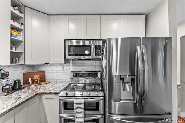 6549 Modoc Ln, Evergreen, CO 80439 - kitchen with appliances with stainless steel finishes, open shelves, backsplash, and white cabinets