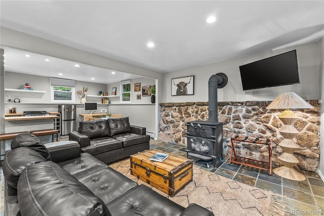 6549 Modoc Ln, Evergreen, CO 80439 - living area with stone tile flooring, recessed lighting, a wood stove, and a baseboard radiator