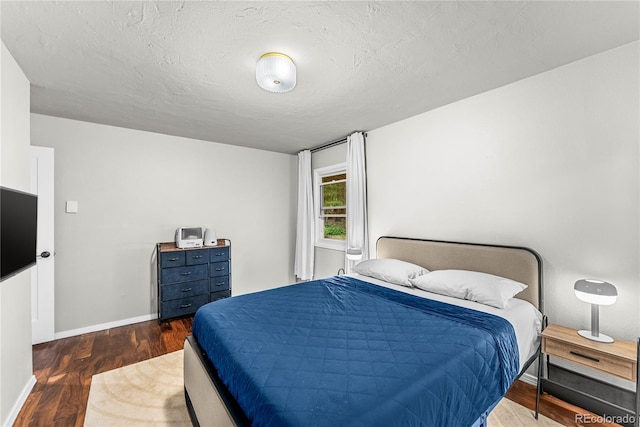 6549 Modoc Ln, Evergreen, CO 80439 - bedroom with wood finished floors and a textured ceiling
