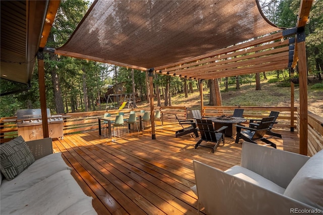 6549 Modoc Ln, Evergreen, CO 80439 - wooden terrace with a playground, grilling area, and an outdoor living space with a fire pit