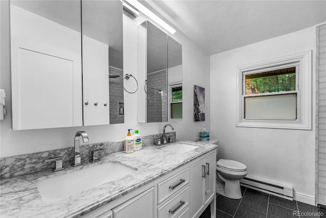 6549 Modoc Ln, Evergreen, CO 80439 - bathroom featuring baseboard heating, double vanity, a tile shower, and tile patterned flooring