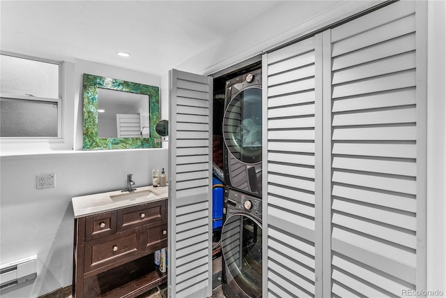 6549 Modoc Ln, Evergreen, CO 80439 - bathroom with stacked washing machine and dryer, a baseboard radiator, and vanity