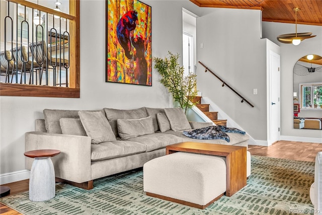 6549 Modoc Ln, Evergreen, CO 80439 - living room featuring wooden ceiling, wood finished floors, stairs, and arched walkways