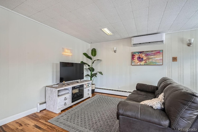 living room with a baseboard heating unit, baseboards, wood finished floors, and a wall mounted AC