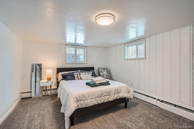 bedroom featuring baseboard heating and dark carpet